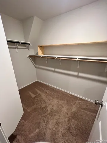 a bathroom with a granite countertop sink a toilet a mirror and shower