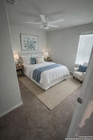 a bedroom with a bed and a window