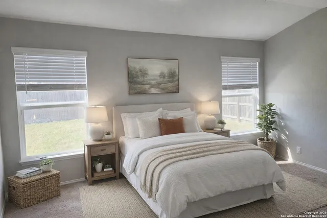 a bedroom with a bed and chandelier