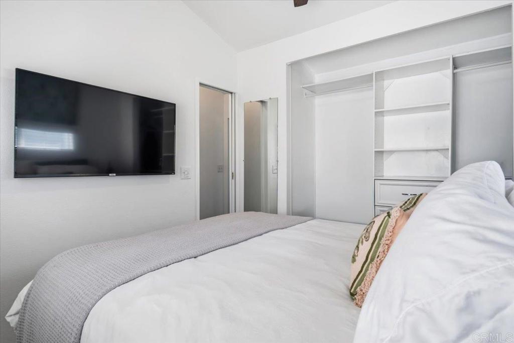 1624 North Coast Highway 101, Unit 6 Encinitas, CA 92024 - Photo 12 of 26 a bedroom with a bed and a flat screen tv