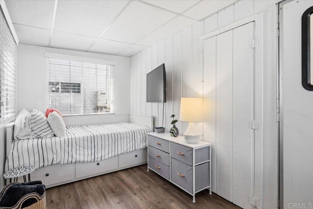 1624 North Coast Highway 101, Unit 6 Encinitas, CA 92024 - Photo 13 of 26 a bedroom with a bed and a window