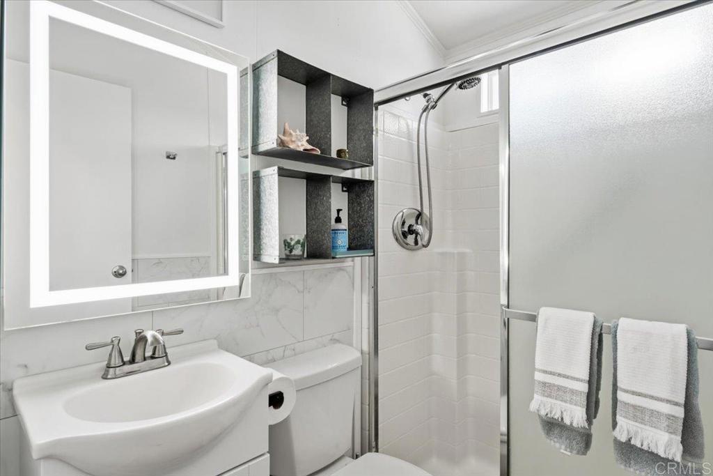 1624 North Coast Highway 101, Unit 6 Encinitas, CA 92024 - Photo 16 of 26 a bathroom with a sink a toilet and shower