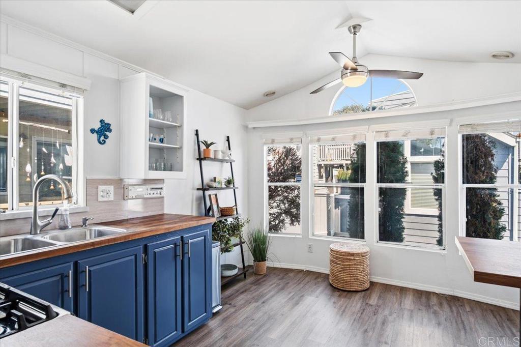 1624 North Coast Highway 101, Unit 6 Encinitas, CA 92024 - Photo 6 of 26 a large room with wooden floor and windows