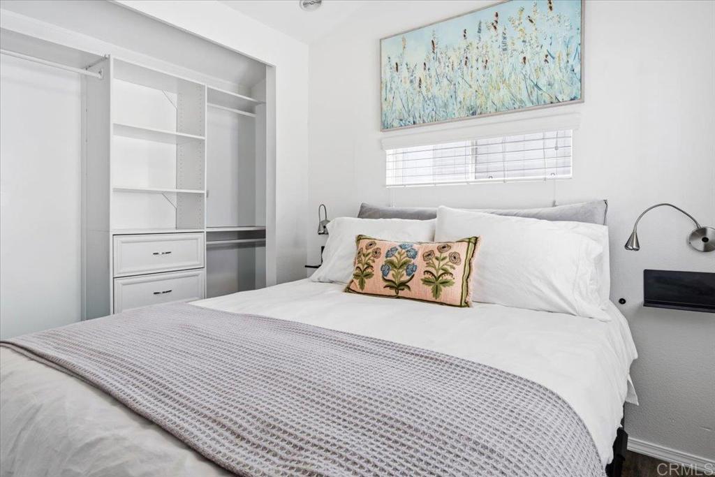 1624 North Coast Highway 101, Unit 6 Encinitas, CA 92024 - Photo 10 of 26 a bedroom with a large bed and a window