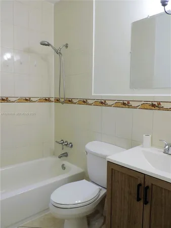 a bathroom with a toilet and a bath tub