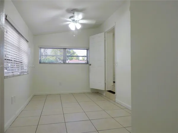 a view of kitchen and utility room in hallway