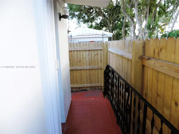 a view of a backyard with wooden fence