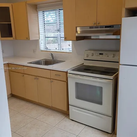 a stove top oven sitting inside of a kitchen