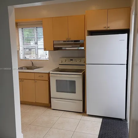 a kitchen with a stove and a refrigerator