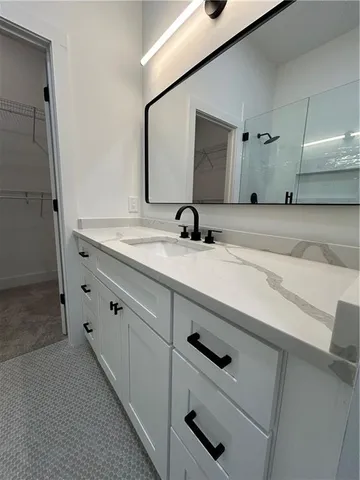 a bathroom with a sink a toilet a shower and a mirror
