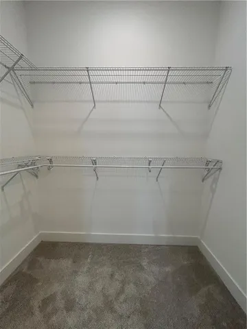 a spacious bathroom with a granite countertop sink a mirror and shower