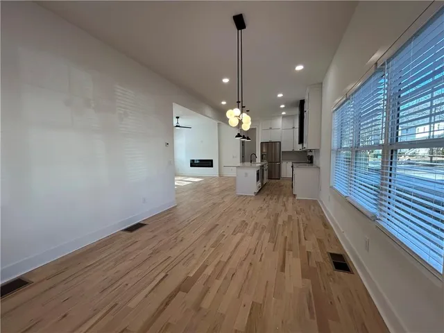a kitchen with kitchen island granite countertop a sink a counter space stainless steel appliances and cabinets
