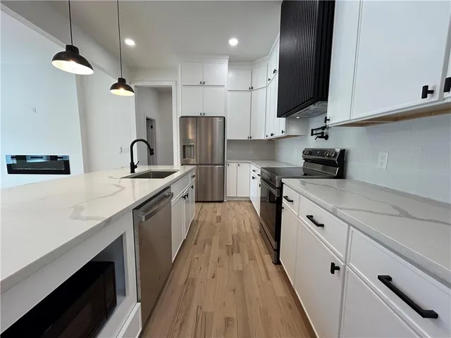 a kitchen with a sink and chandelier