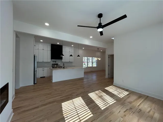 a kitchen with stainless steel appliances kitchen island a sink a stove and refrigerator