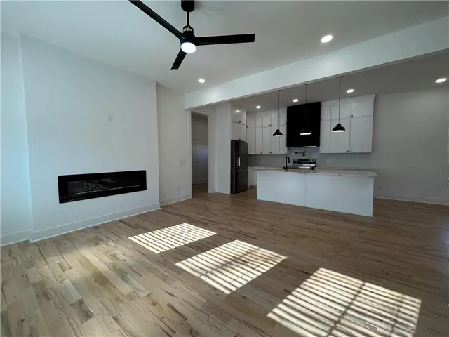 a view of a kitchen with a sink and a large mirror