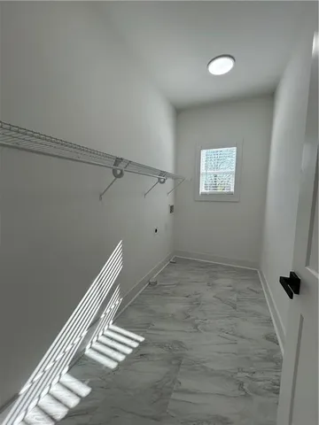 a bathroom with a toilet a sink a mirror a shower a vanity and window