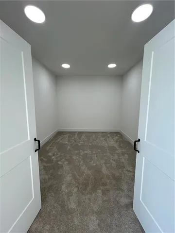 a bathroom with double vanity and a mirror