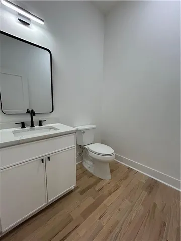 an empty room with windows and ceiling fan