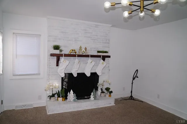 an empty room with a fireplace and wooden floor