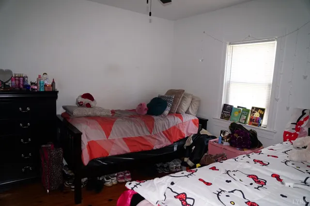 a bedroom with two bed and a dresser