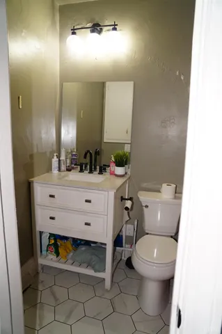 a bathroom with a sink mirror vanity and toilet