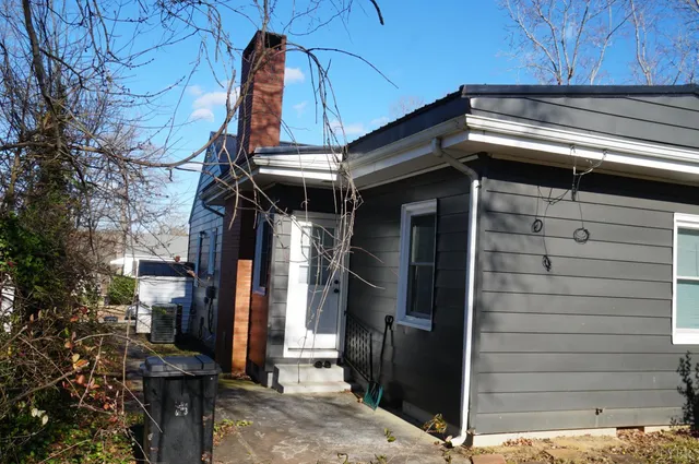 a view of a house with a door and wooden walls