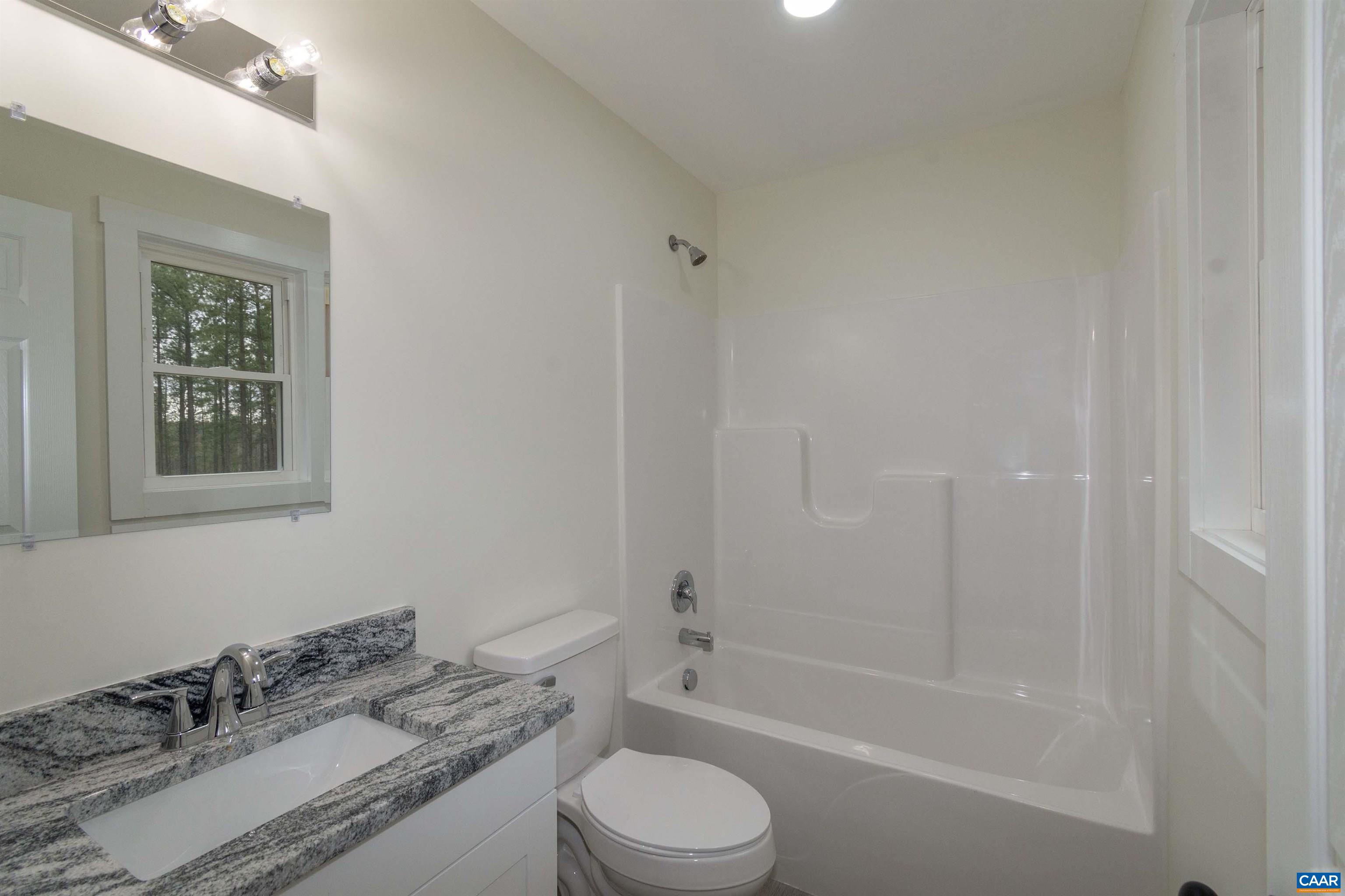 15301 Shirley Road Unionville, VA 22567 - Photo 12 of 27 a bathroom with a granite countertop sink toilet and shower