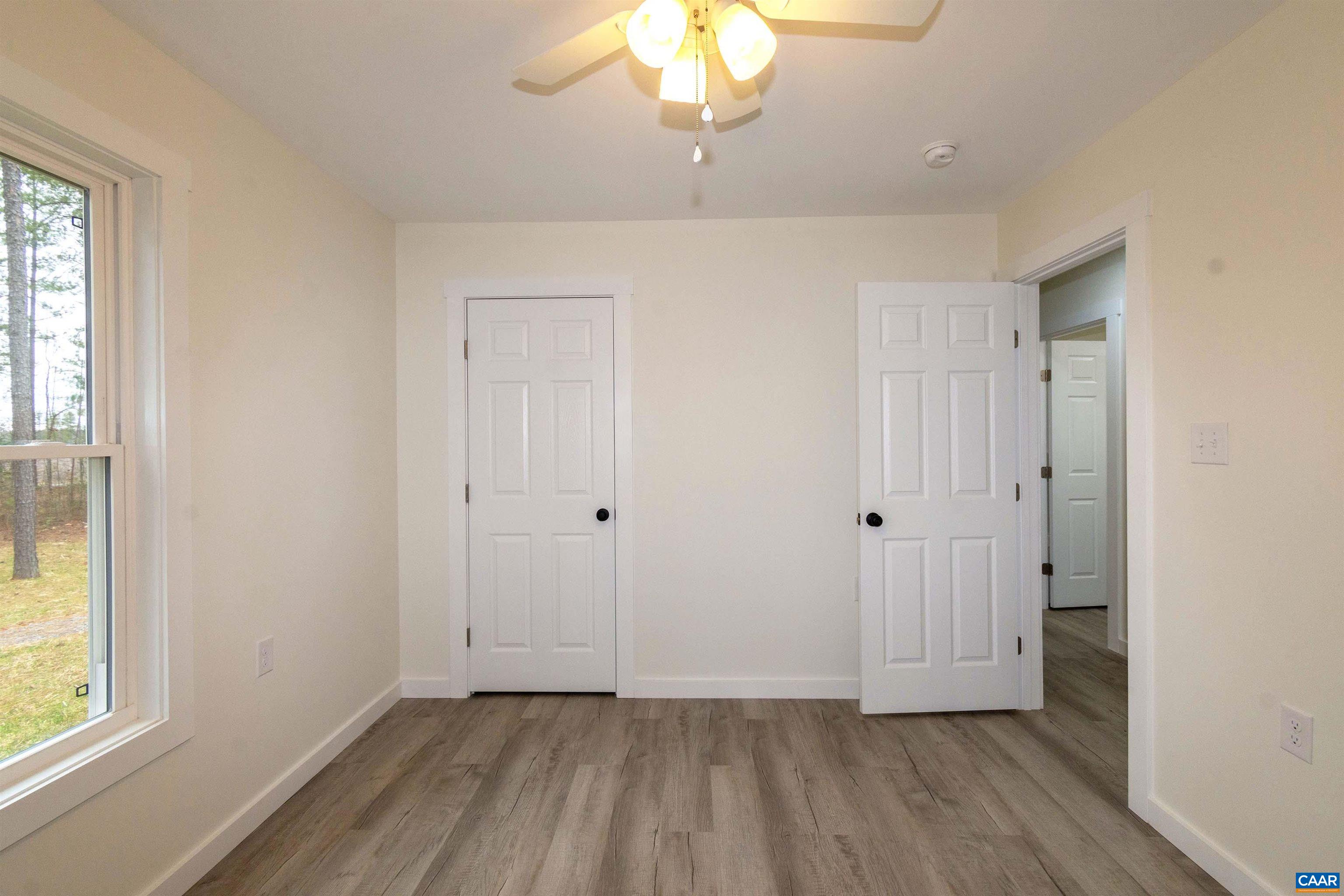 15301 Shirley Road Unionville, VA 22567 - Photo 13 of 27 a view of an empty room with wooden floor and a window