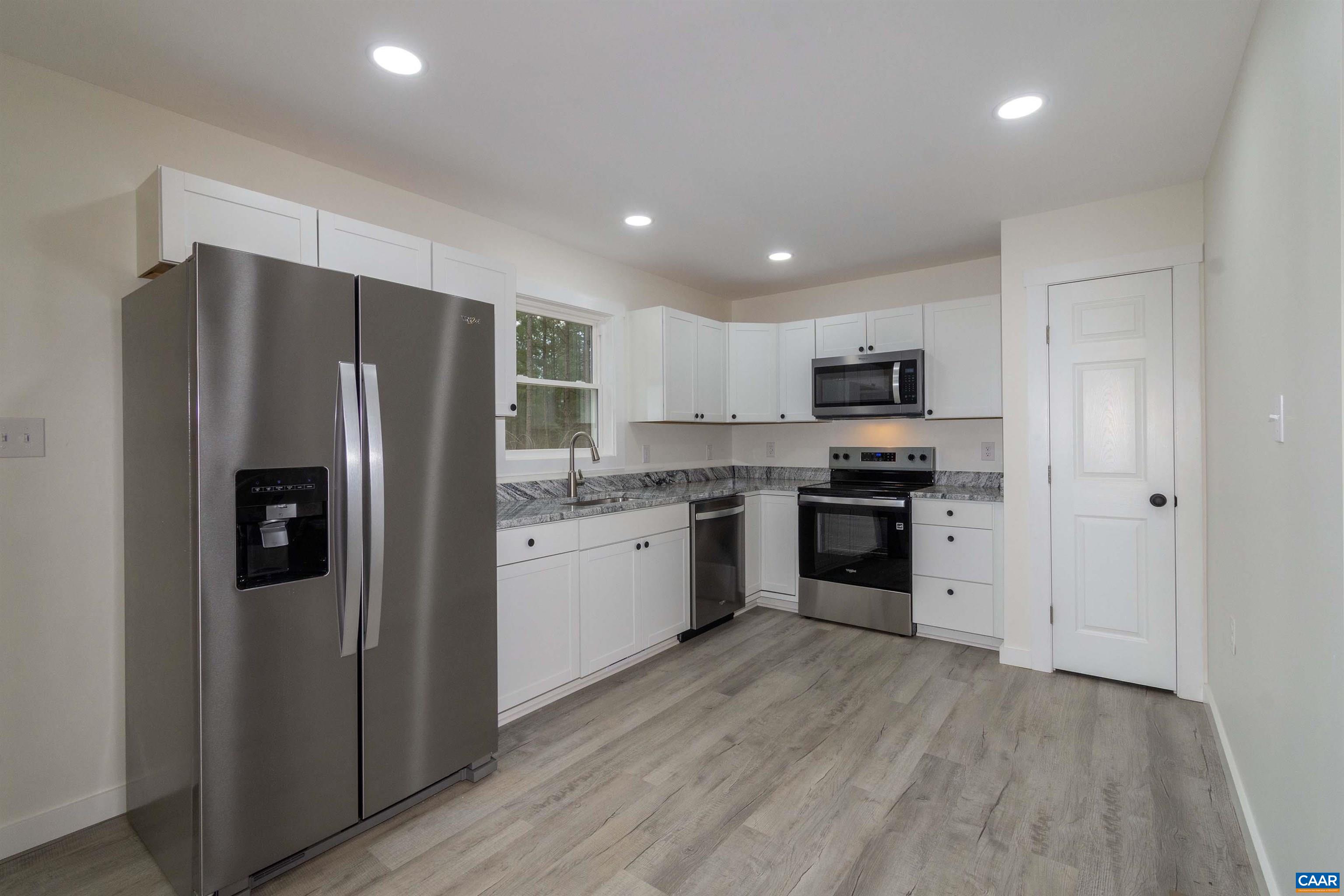 15301 Shirley Road Unionville, VA 22567 - Photo 7 of 27 a kitchen with a refrigerator a sink and cabinets