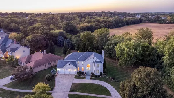 an aerial view of residential houses and outdoor space
