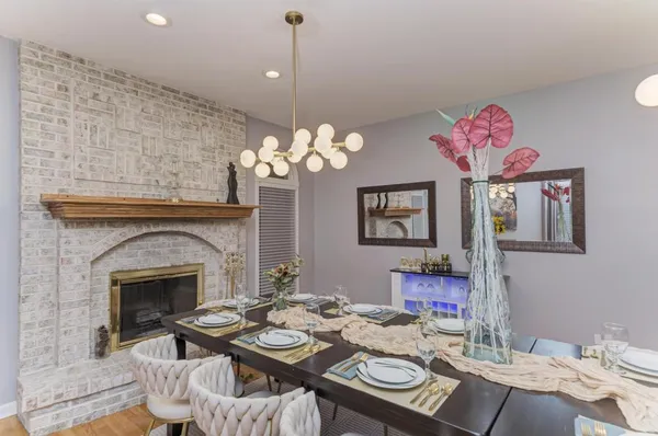 a view of a dining room with furniture and chandelier