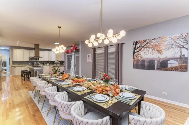 a view of a dining room with furniture and chandelier