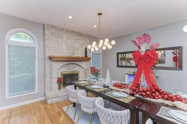 a view of a dining room with furniture and chandelier