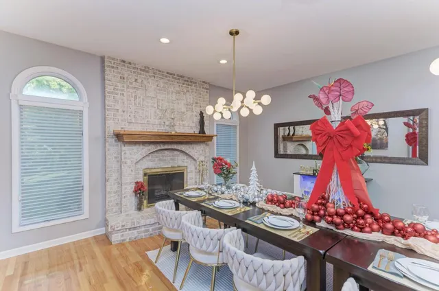 a view of a dining room with furniture and chandelier