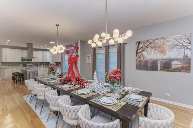 a kitchen with a stove a sink dishwasher and a refrigerator with wooden floor