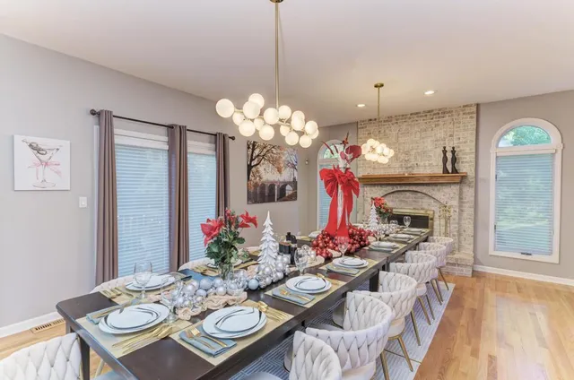 a kitchen with kitchen island granite countertop a sink dishwasher stove and white cabinets