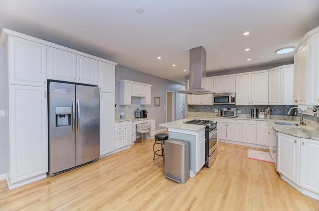 a kitchen with stainless steel appliances granite countertop a sink and a microwave