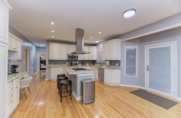 a kitchen with stainless steel appliances a sink and a refrigerator