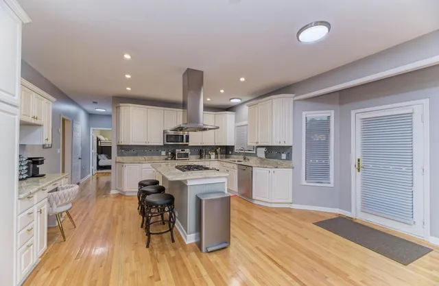 a kitchen with stainless steel appliances a sink and a refrigerator