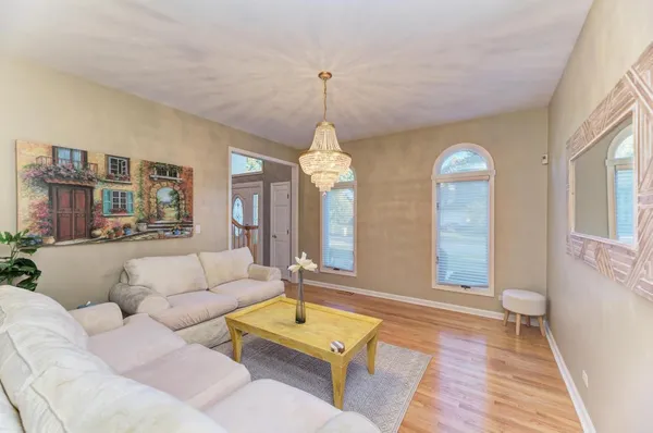 a living room with furniture a mirror and a table
