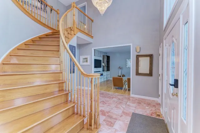 a view of staircase with railing and white walls