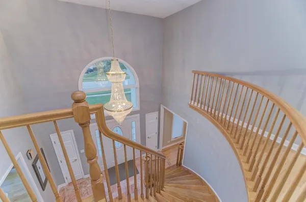 a living room with a flat screen tv a couch and a large window with wooden floor