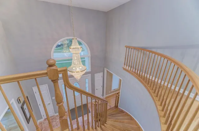 a living room with a flat screen tv a couch and a large window with wooden floor