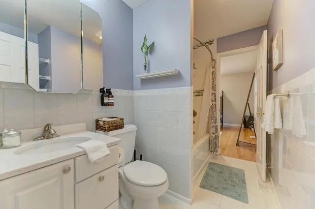 a room with furniture pool table and wall paintings