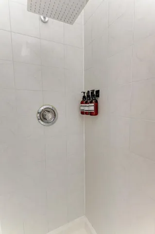 a room with pool table a flat screen tv and windows