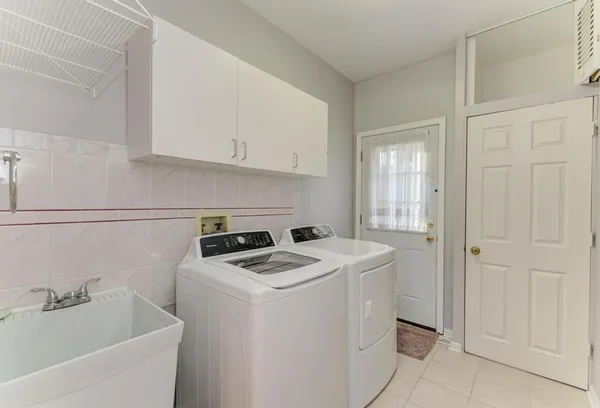 a view of a house with a yard and sitting area