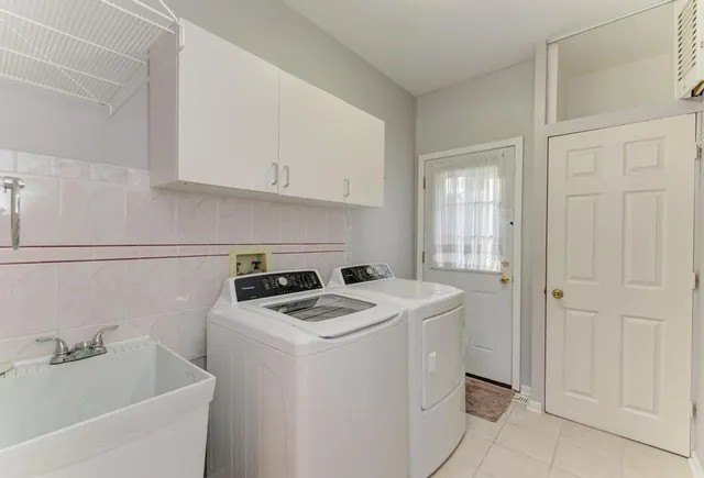 a view of a house with a yard and sitting area
