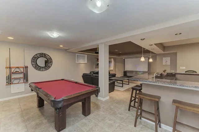 a view of a brick house with large windows and a yard