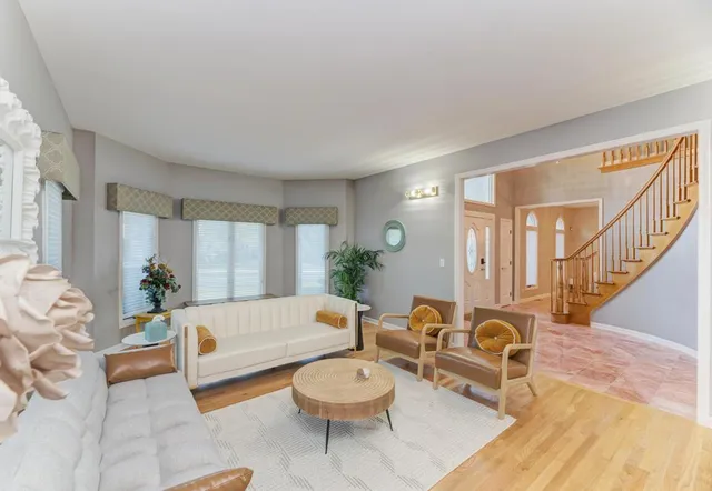 a view of a dining room with furniture a chandelier and wooden floor
