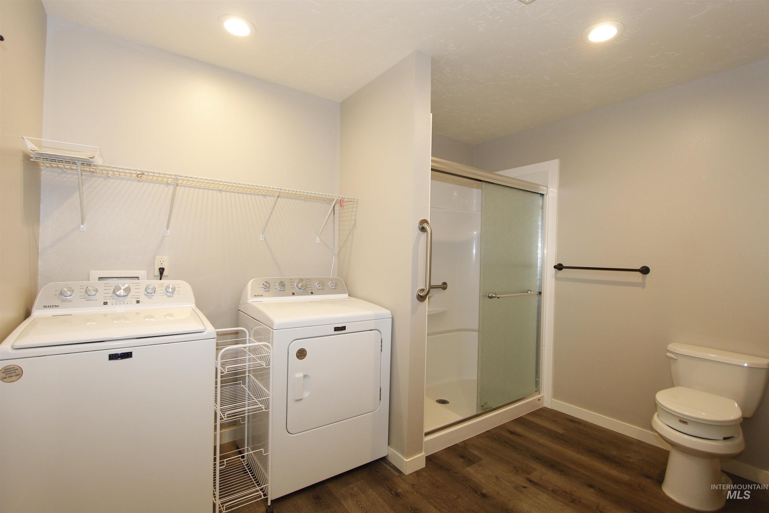 3434 5th Street, Unit B Lewiston, ID 83501 - Photo 14 of 19 Washroom featuring dark wood-style floors, recessed lighting, and separate washer and dryer